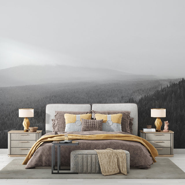 Black and white forest mural creating depth in modern living room with grey sofa and minimal decor