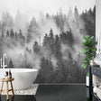 Black and white forest wallpaper creating depth in a minimal Scandinavian living room