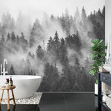 Black and white forest wallpaper creating depth in a minimal Scandinavian living room