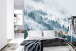 Forest mural wallpaper creating depth in modern living room with grey sofa and natural light