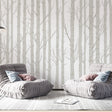 Birch tree wallpaper creating a serene atmosphere in a modern living room with natural light and minimal furniture