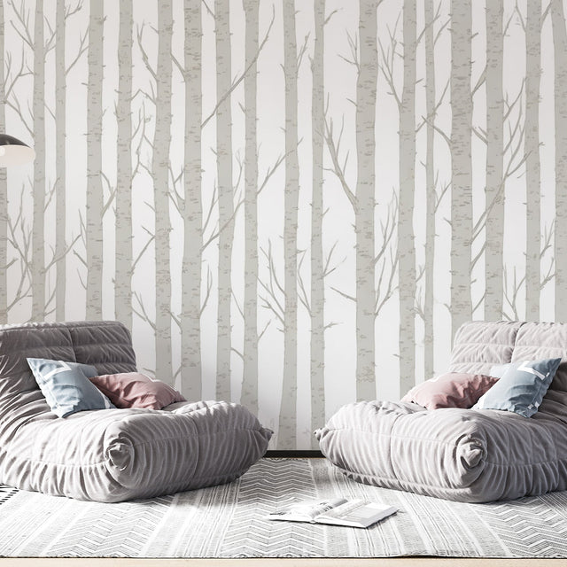 Birch tree wallpaper creating a serene atmosphere in a modern living room with natural light and minimal furniture