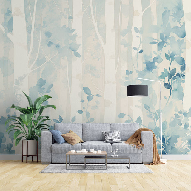 Blue forest wallpaper mural creating a peaceful atmosphere in a modern living room with white furniture