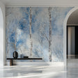 Winter birch tree wallpaper creating a peaceful atmosphere in a modern living room with white furniture