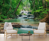 Tropical waterfall wallpaper creating a stunning focal point in a modern living room with white furniture