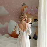 Pink fox wall mural bringing warmth to a child's reading nook with soft lighting