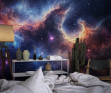 Space themed home office featuring cosmic nebula wallpaper with deep purple tones