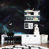 Galaxy wallpaper in modern bedroom creates dreamy atmosphere with soft nebula glow