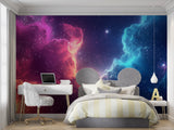 Reading nook with pink and blue space wallpaper creating a cozy corner