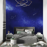 Night sky mural wallpaper in a cozy reading nook with soft lighting