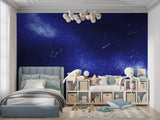 Space themed wallpaper transforming a home office with deep blue constellation design