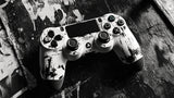 Design file showing detailed black and white PlayStation controller pattern with paint splash effect