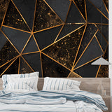 3D geometric black and gold cube wallpaper in a modern living room with leather furniture