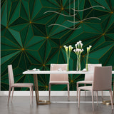 Green and gold geometric wallpaper creating depth in a modern living room with minimal furniture