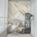 Gold geometric Art Deco wallpaper in modern living room with gray sofa and natural light