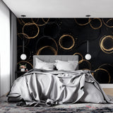Geometric black and gold wallpaper adding luxury to a master bedroom wall