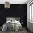 Black and gold geometric wallpaper in modern living room creates sophisticated atmosphere