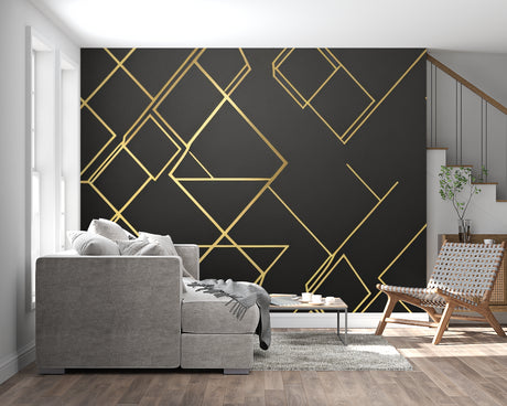Geometric black and gold diamond wallpaper in modern living room with grey sofa