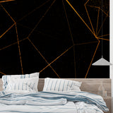 Modern geometric black and gold wallpaper in a minimalist living room setting with clean lines and contemporary furniture