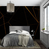 Black and gold geometric wallpaper making a statement in an elegant dining room space