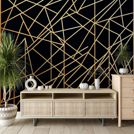 Black and gold geometric wallpaper creating modern elegance in a luxury dining room with pendant lighting