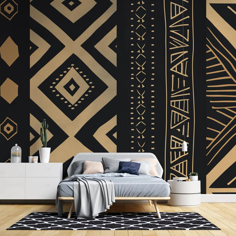 Black and gold geometric tribal wallpaper in modern living room creating dramatic accent wall with warm lighting