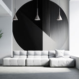 Modern geometric circle wallpaper creating a bold statement wall in a minimalist living room with natural lighting