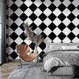 Black and white geometric diamond wallpaper in a modern living room creating a stunning focal wall