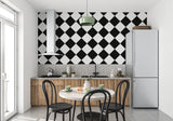 Black and white geometric wallpaper adding sophistication to an entrance hall