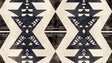 Modern living room with striking Black and White Geometric Tribal Wallpaper creating a bold accent wall