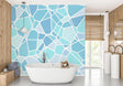 Modern blue geometric wallpaper creating depth in a minimalist living room with natural lighting