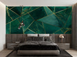 Geometric emerald green and gold wallpaper in modern living room setting with gray sofa and pendant lights