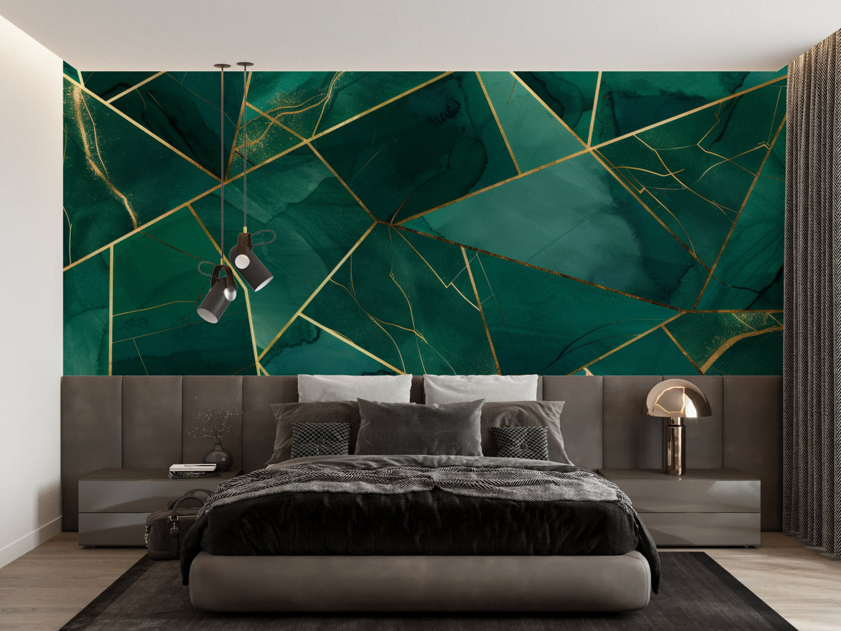 Geometric emerald green and gold wallpaper in modern living room setting with gray sofa and pendant lights