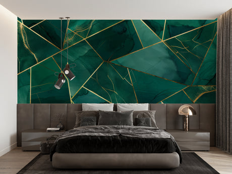 Geometric emerald green and gold wallpaper in modern living room setting with gray sofa and pendant lights