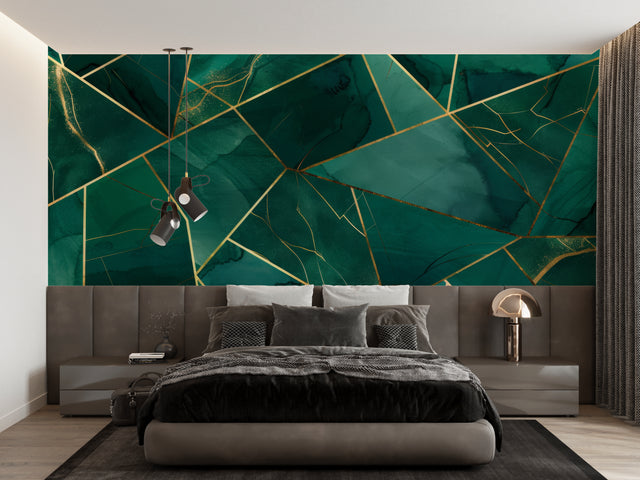 Geometric emerald green and gold wallpaper in modern living room setting with gray sofa and pendant lights