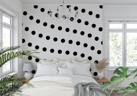 Gold polka dot wallpaper in modern living room creates elegant atmosphere with natural light highlighting metallic details