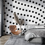 Geometric gold dot wallpaper as bedroom feature wall adding warm, sophisticated touch