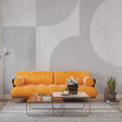 Modern Art Deco geometric wallpaper creating an elegant statement wall in a minimalist living room with curved furniture