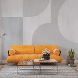 Modern Art Deco geometric wallpaper creating an elegant statement wall in a minimalist living room with curved furniture