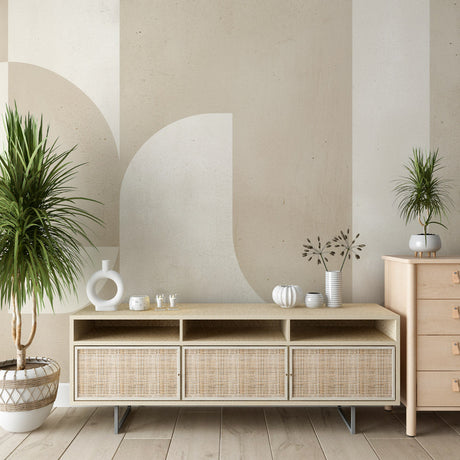 Modern geometric wallpaper with circular patterns in a bright living room setting with minimalist furniture