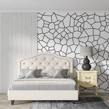 Modern geometric wallpaper in minimalist living room showing black and white pattern