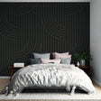 Modern geometric wallpaper with black curved lines creating depth in a minimalist living room setting