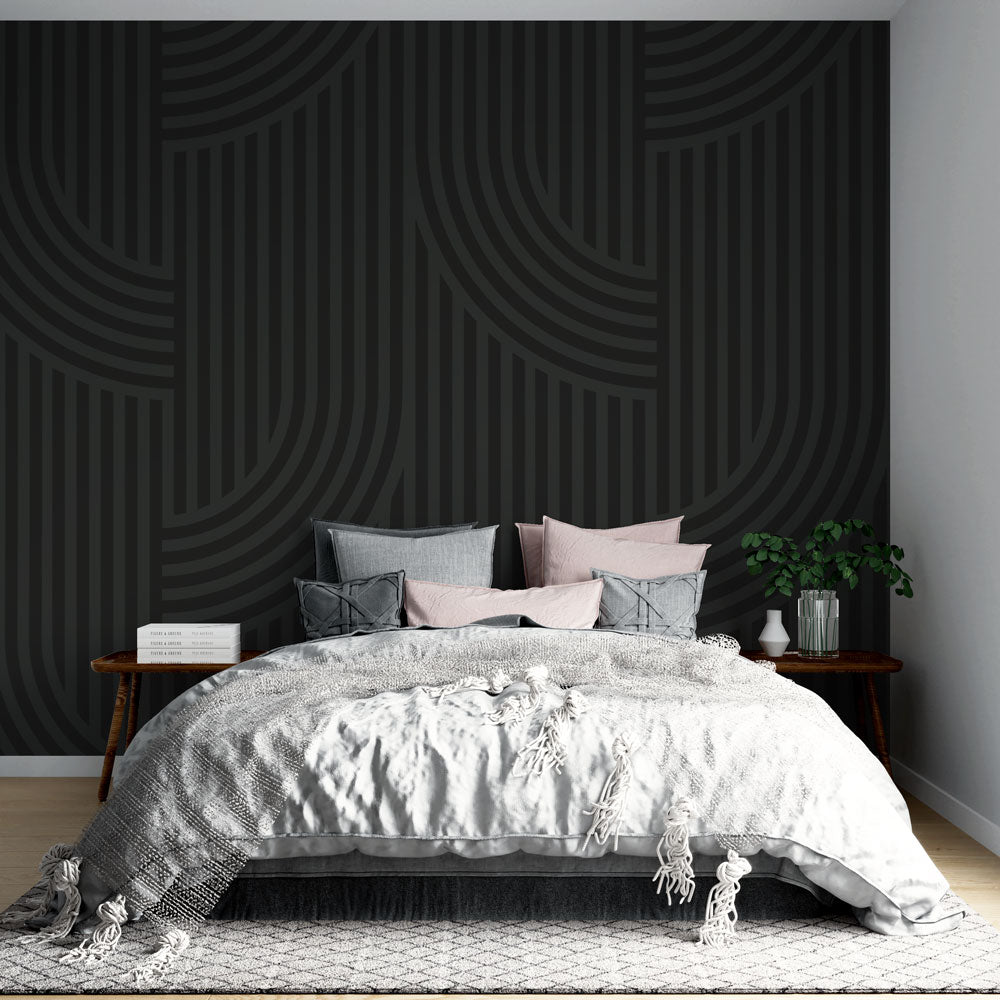 Modern geometric wallpaper with black curved lines creating depth in a minimalist living room setting