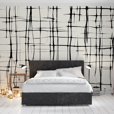 Modern black grid geometric wallpaper creating a striking focal point in a minimalist living room with natural light