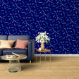 Modern geometric blue wallpaper creating depth in a minimalist living room with natural light
