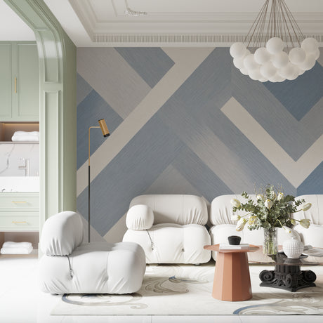 Modern geometric wallpaper in a bright living room with grey sofa and large windows