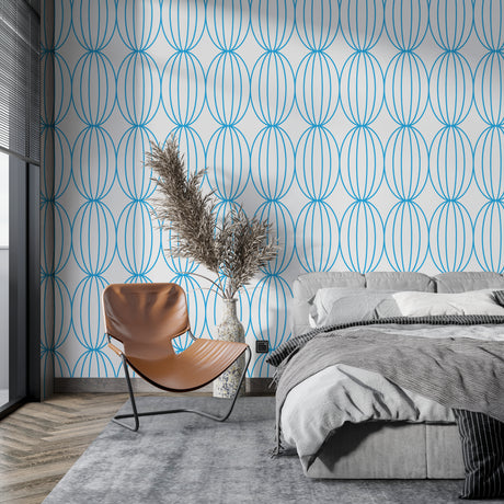 Modern blue geometric wallpaper in a bright living room showing flowing circle pattern