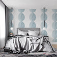 Modern blue circle wallpaper in a bright Scandinavian living room, showing geometric pattern flow
