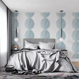 Modern blue circle wallpaper in a bright Scandinavian living room, showing geometric pattern flow
