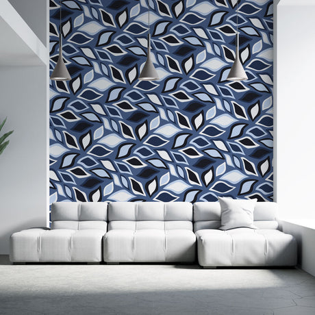 Modern geometric leaf wallpaper in blue tones creating a striking accent wall in a minimalist living room setting